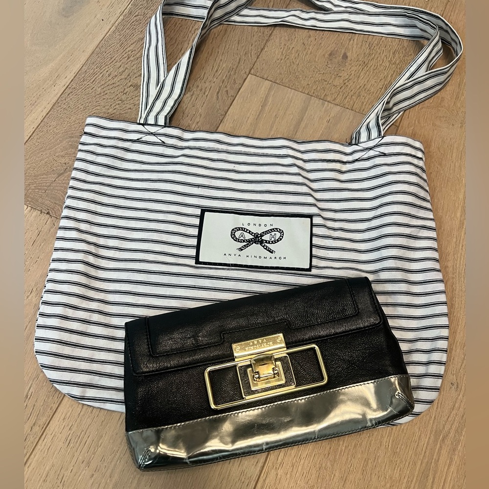Anya Hindmarch black clutch with metal hardware